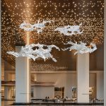 Transparent waves hanging in the air in the hotel lobby, artistic decorative resin ornaments hanging from the ceiling of the sales office in the shopping mall